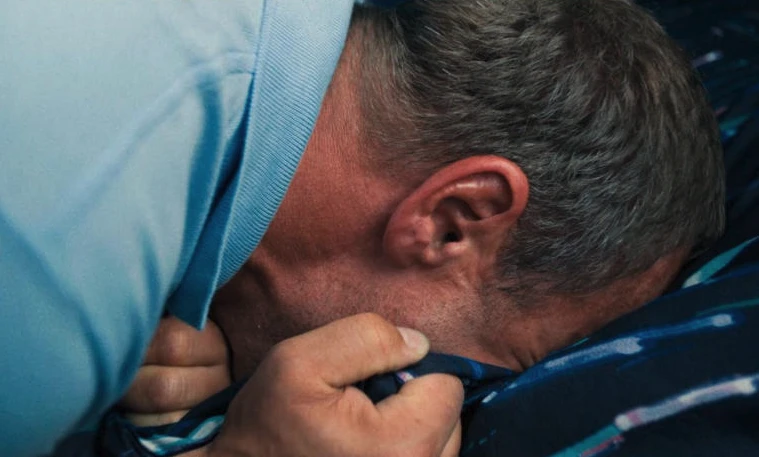 Adolescence, dad crying on pillow
